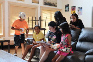 Kat Maclean and Indigenous youth at Beardy's Camp, Gordon Tootoosis Nīkānīwin Theatre